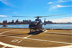 Silk Sky Air helicopter on the helipad overlooking the city skyline